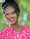 Portrait of a smiling Filipina woman outdoors in Davao Region, Philippines.